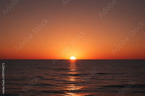 sunset over the ocean with a bright orange sun setting