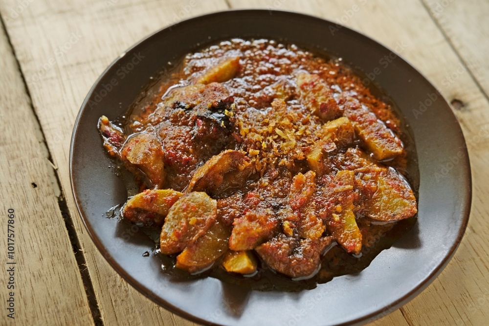A mouthwatering plate of Sambal Jengkol, a traditional Indonesian dish featuring stinky beans (jengkol) cooked in a rich, spicy chili sauce. This bold-flavored dish is perfect for spice lovers food A mouthwatering plate of Sambal Jengkol, a traditional Indonesian dish featuring stinky beans (jengkol) cooked in a rich, spicy chili sauce. This bold-flavored dish is perfect for spice lovers food