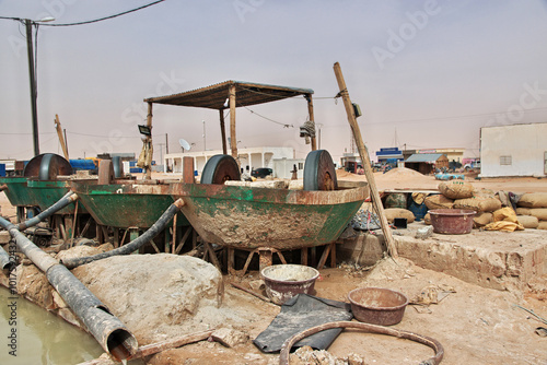 Obraz na płótnie Nouakchott, Mauritania - 06 Jan 2022: Factory next to a gold mine in Sahara desert not far Nouakchott, Mauritania, West Africa w salonie
