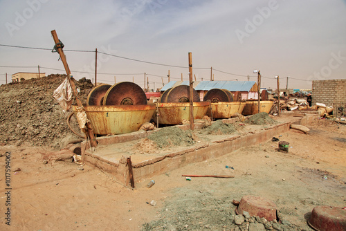 Obraz na płótnie Nouakchott, Mauritania - 06 Jan 2022: Factory next to a gold mine in Sahara desert not far Nouakchott, Mauritania, West Africa w salonie