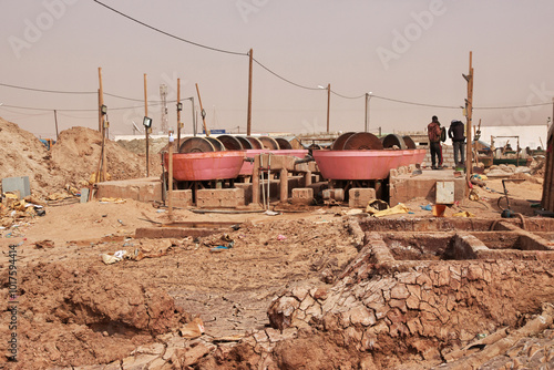 Obraz na płótnie Nouakchott, Mauritania - 06 Jan 2022: Factory next to a gold mine in Sahara desert not far Nouakchott, Mauritania, West Africa w salonie