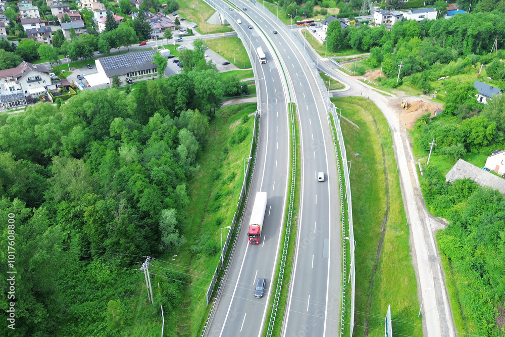 Aerial shot of white truck on empty country road