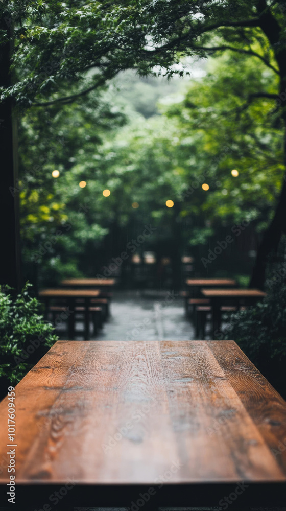 Empty wooden table in a lush green garden with string lights. Empty wooden table in a lush green garden with string lights.