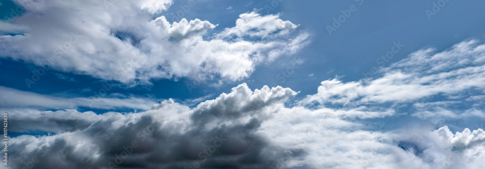 Fototapeta premium Banner Tropical summer blue sky fluffy white cloud summertime on light sunny day cloudscape. Panoramic Clear bright blue skyline spring sunlight climate background. Heaven blue ecology for web banner