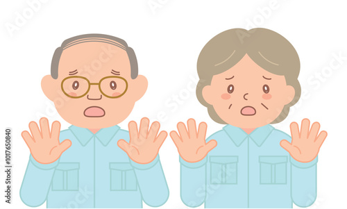 手のひらを向けて拒否する作業着のシニアスタッフ