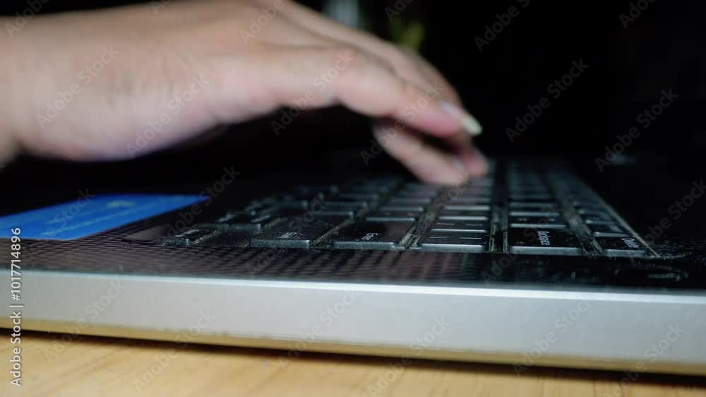 Close up man hands are typing on a laptop keyboard, a man works, develops a business, studies, plays a computer game in darkness operating room, cyber security concept. Hacker using laptop Close up man hands are typing on a laptop keyboard, a man works, develops a business, studies, plays a computer game in darkness operating room, cyber security concept. Hacker using laptop