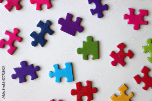 Colorful jigsaw puzzle pieces on white background. Flat lay.