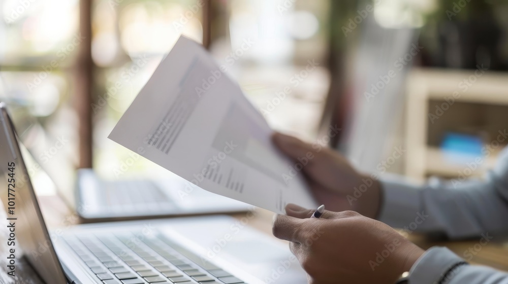 Empowered Professional Closeup of Person Holding Paper at Modern Desk with Laptop Business Concept Stock Photo Empowered Professional Closeup of Person Holding Paper at Modern Desk with Laptop Business Concept Stock Photo