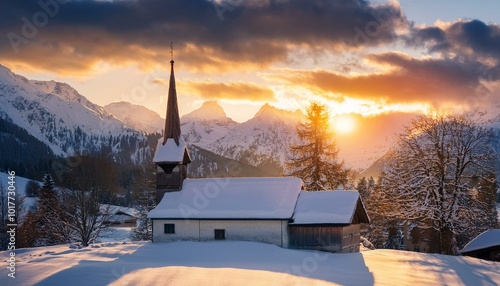 A small, rustic church with a snow-covered roof, nestled in a peaceful winter village as the sun sets behind the mountains.