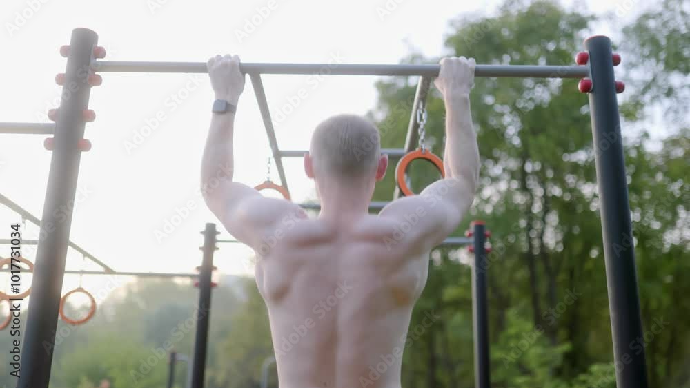 Intense Outdoor Strength and Endurance Workout on a Sports Field, naked torso man, back view Intense Outdoor Strength and Endurance Workout on a Sports Field, naked torso man, back view