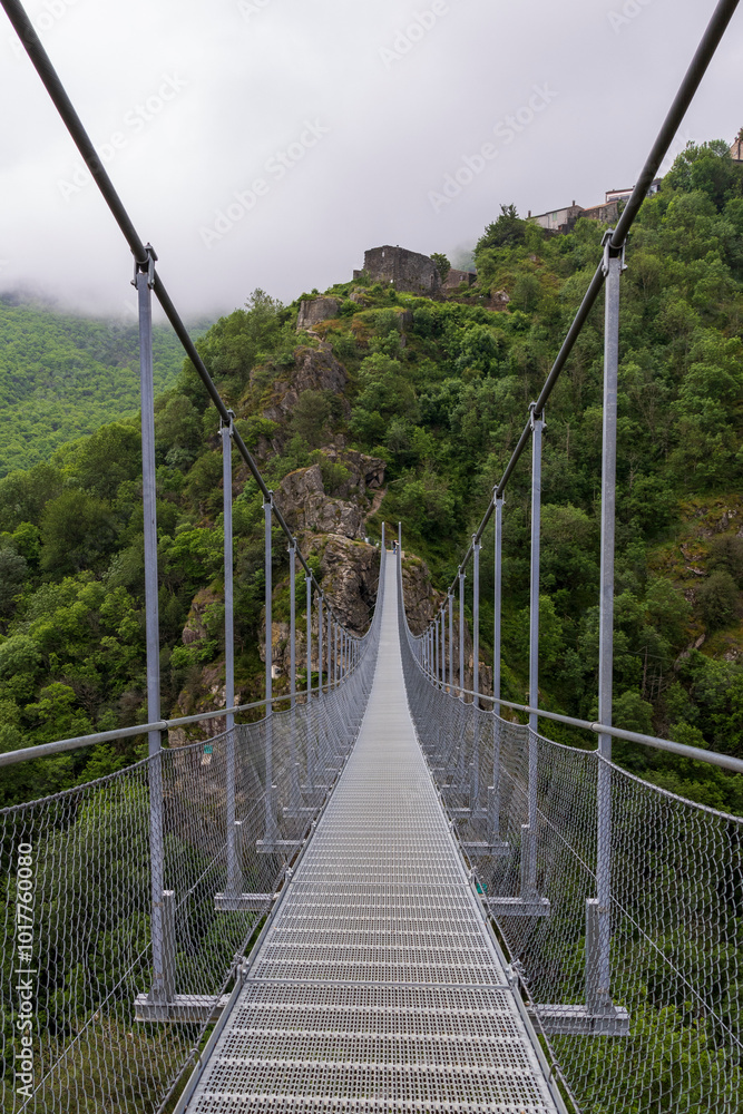 Obraz premium Footbridge to the village of Hautpoul near Mazamet. Tarn. Occitanie. France