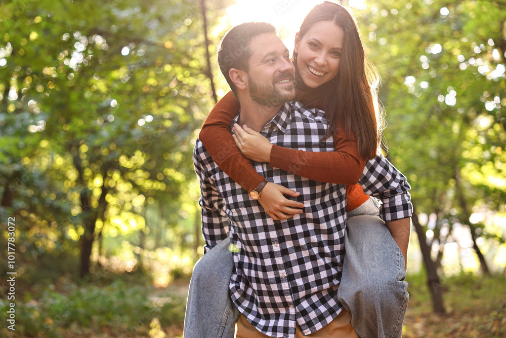 Fototapeta premium Beautiful couple having fun together in park on autumn day