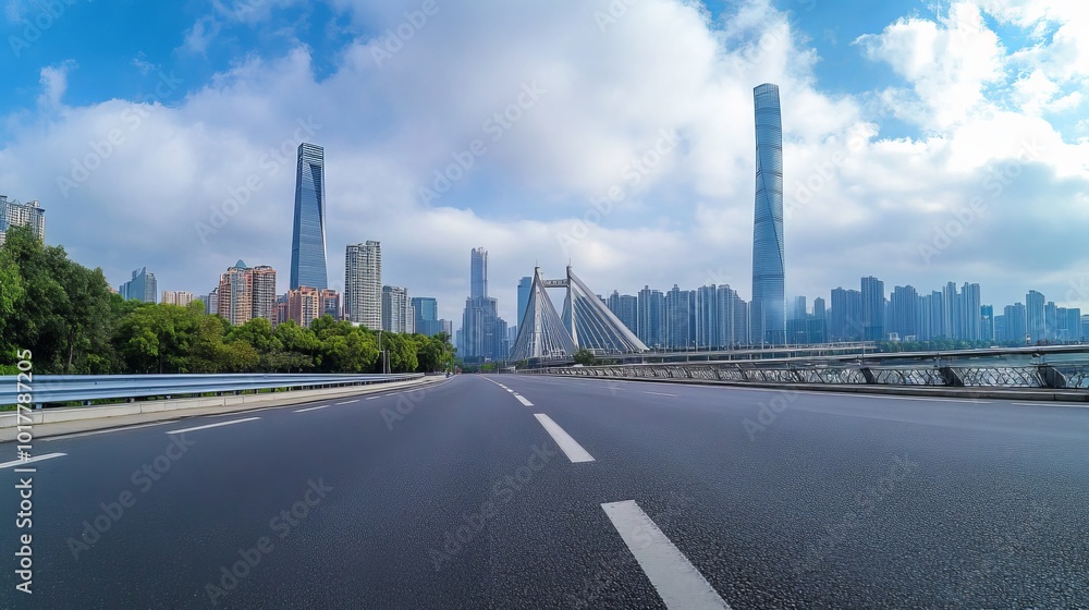 An asphalt road leads to a bridge, framed by the modern city buildings of Guangzhou. An asphalt road leads to a bridge, framed by the modern city buildings of Guangzhou.