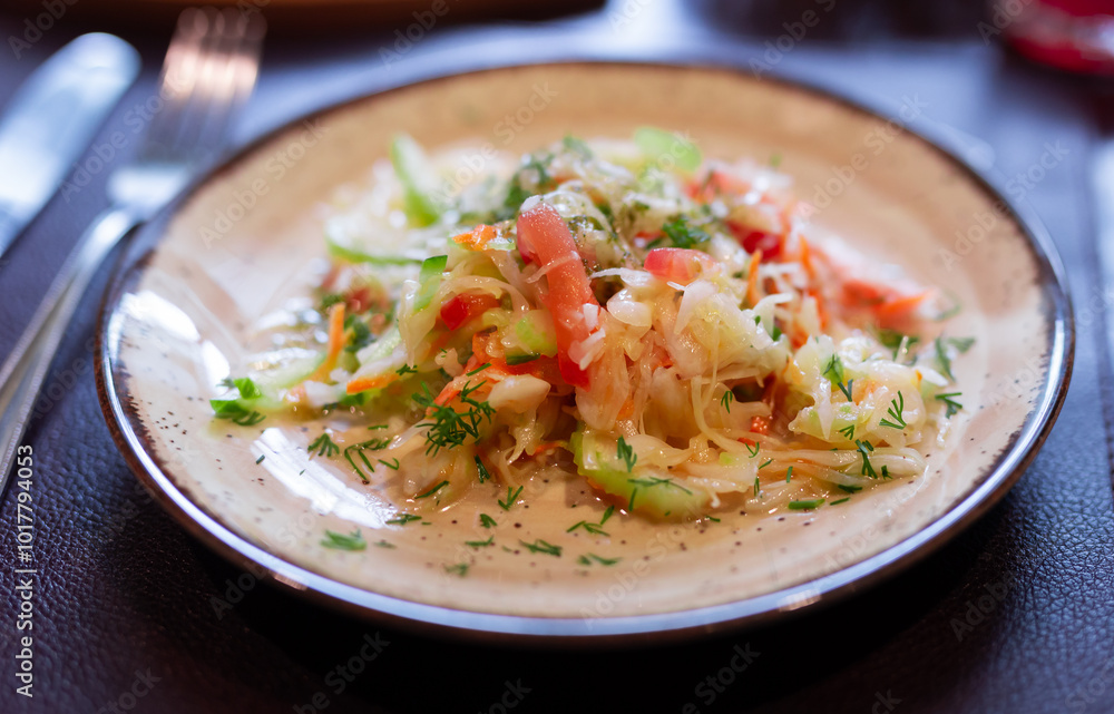 Plate with fresh vegetable salad of tomato, cucumber and celery close up Plate with fresh vegetable salad of tomato, cucumber and celery close up