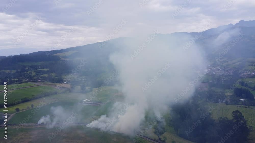 Prescribed fires on farmland in Ecuador emit smoke, drifting over rural agricultural regions, aerial dolly Prescribed fires on farmland in Ecuador emit smoke, drifting over rural agricultural regions, aerial dolly