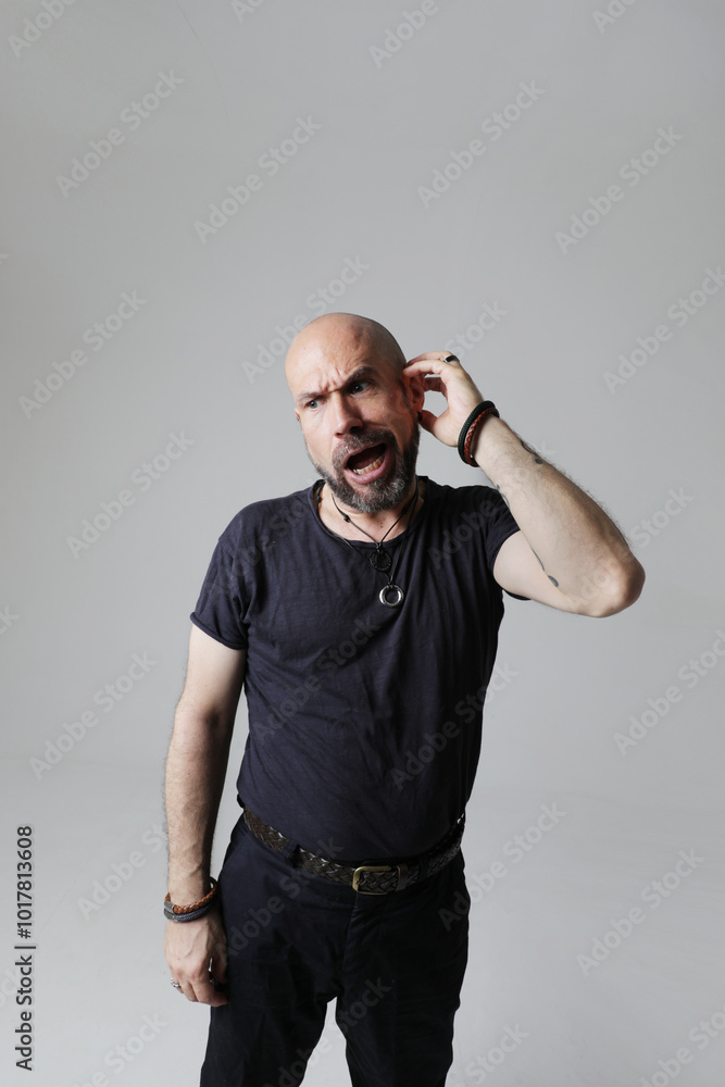 Portrait of mature bald man with beard, posing confidently indoors. Portrait of mature bald man with beard, posing confidently indoors.