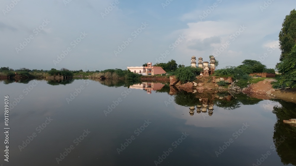 Scenic Reflections of a Riverside well and Rural Landscape Under Clear Skies Scenic Reflections of a Riverside well and Rural Landscape Under Clear Skies