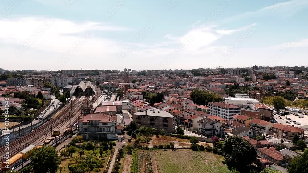 Aerial - train station and tracks amid buildings in Estação Ferroviária de Ermesinde, Porto, Portugal Aerial - train station and tracks amid buildings in Estação Ferroviária de Ermesinde, Porto, Portugal