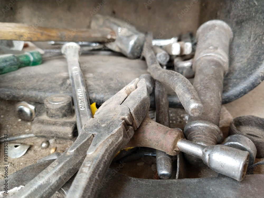 Flat lay Old hand tools ,Pliers screwdriver wrench rusted iron metal tools on Steel plate at garage Flat lay Old hand tools ,Pliers screwdriver wrench rusted iron metal tools on Steel plate at garage