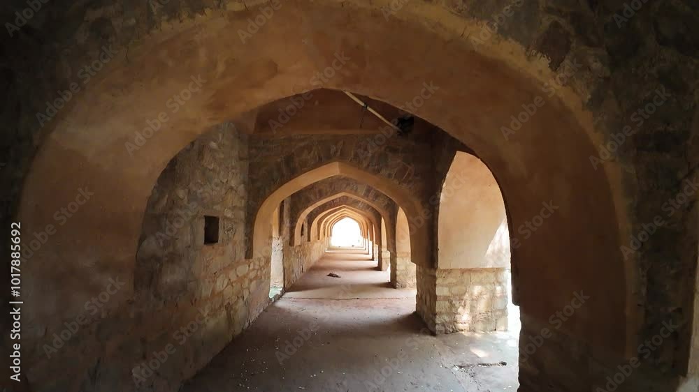 wander through a series of old stone arches in a historical site at Mehrauli Archeological Park , Delhi, India wander through a series of old stone arches in a historical site at Mehrauli Archeological Park , Delhi, India