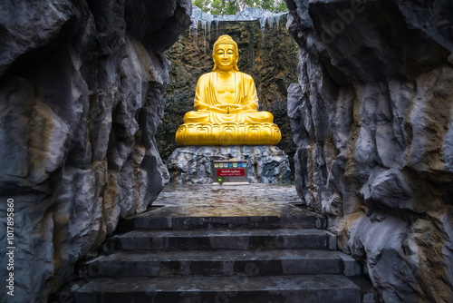 Samut Sakhon, Thailand - September, 25, 2024 : Golden Buddha Statue in Serene Cave in Lak Si Temple at Samut Sakhon, Thailand. photo