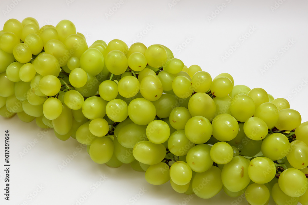 Grapes in white on green. fresh fruit concept. bunch of greens on a white with grapes. a bunch of grapes on a white with a bunch lifestyle of greens. Grapes in white on green. fresh fruit concept. bunch of greens on a white with grapes. a bunch of grapes on a white with a bunch lifestyle of greens.