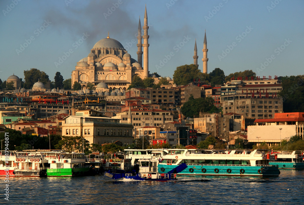 Naklejka premium Photo with view of Suleymaniye Mosque on the hill and buildings on the Bosphorus embankment in the historical part of Istanbul, Turkey