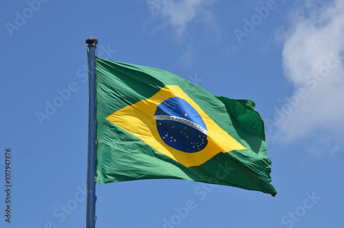 Flag of Brazil fluttering in the wind. In the center of the flag with the words 