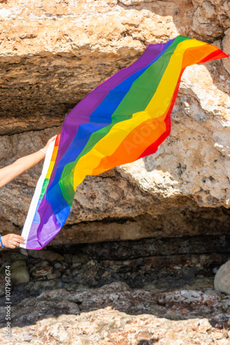 woman, middle aged, outdoors waving pride flag, concept of libertat, equality photo