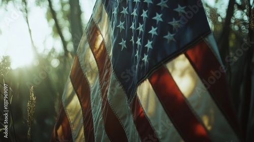 American flag waving in the sunlight among trees during golden hour in a sere...