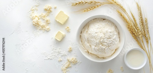 Ingredients for baking: flour, butter, yogurt, and wheat on a clean white sur...