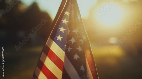 American flag waving in the sunlight among trees during golden hour in a sere...