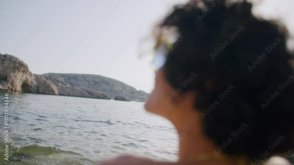 Woman enjoying the summer sun on holiday on the beach of the Frioul Islands, Marseille, France Woman enjoying the summer sun on holiday on the beach of the Frioul Islands, Marseille, France