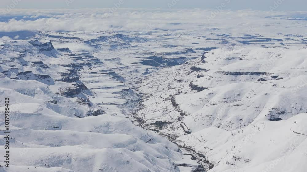 Aerial view of cliffs and mountains of KwaZulu-Natal highlands near Sani Pass covered in snow Aerial view of cliffs and mountains of KwaZulu-Natal highlands near Sani Pass covered in snow