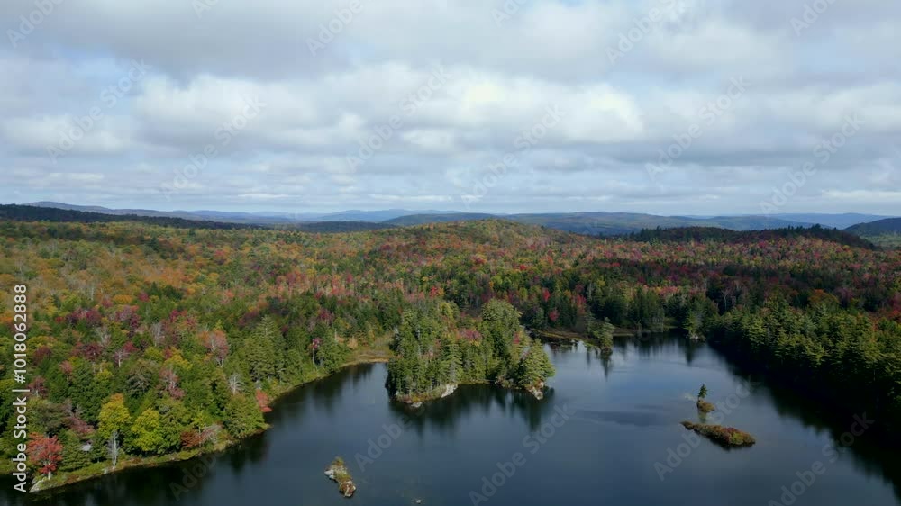 A breathtaking drone shot capturing the calm beauty of Plainfield Pond from above. A breathtaking drone shot capturing the calm beauty of Plainfield Pond from above.