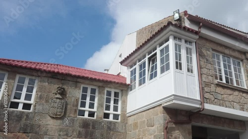 Wallpaper Mural Stone building with red tile roof under a partly cloudy sky and traditional architecture details Torontodigital.ca
