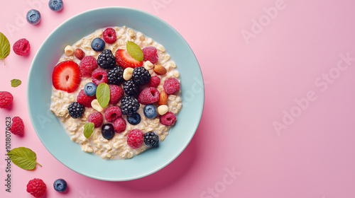 A bowl of oatmeal with strawberries and blueberries on top