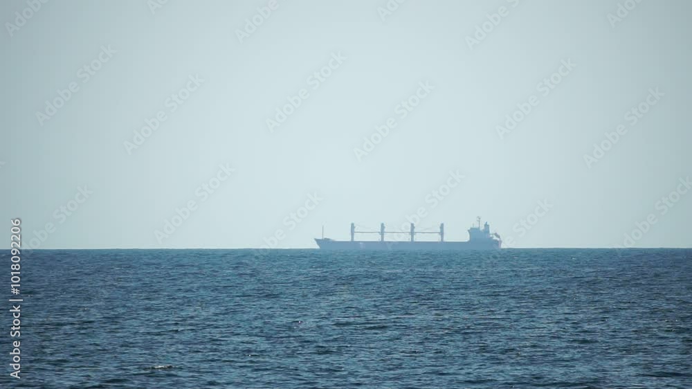 Cargo and dredging industrial ships sailing in to sea horizon. One large cargo ship grain carrier tanker in sea on sunny day. Transport, sea freight, sea transportation of cargo. Aerial view Cargo and dredging industrial ships sailing in to sea horizon. One large cargo ship grain carrier tanker in sea on sunny day. Transport, sea freight, sea transportation of cargo. Aerial view