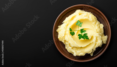 Mashed potatoes in a brown plate on a black background. Restaurant or cafe menu concept. Long banner format. Top view with copy space.