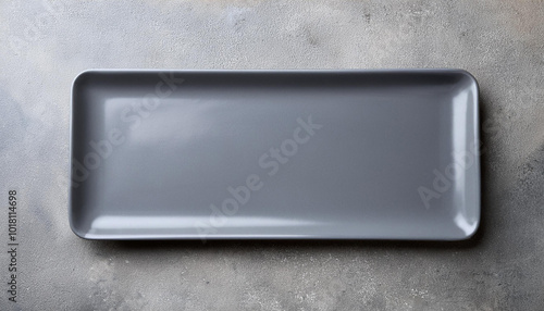 Gray empty rectangular plate over concrete background. photo