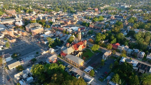 Aerial view of Carlisle, Pennsylvania, featuring a mix of historic buildings, residential areas, and tree-lined streets on a clear day.