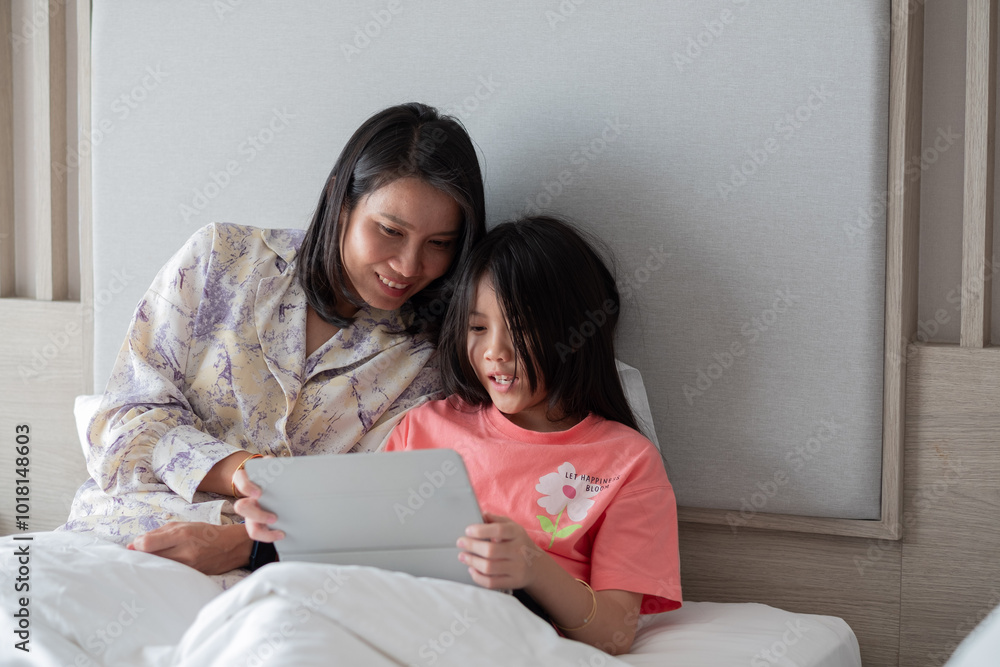 chinese child playing smartphone with mother, kid addicted tablet chinese child playing smartphone with mother, kid addicted tablet