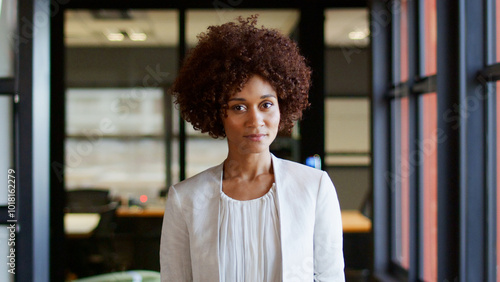 Portrait Of Serious Young Businesswoman Working In Modern Open Plan Office