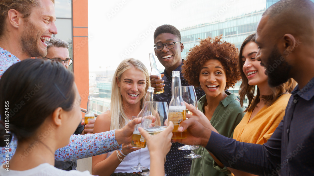 Multi-Cultural Business Team Celebrating Outdoors For After Work Drinks On Office Rooftop Or Bar Multi-Cultural Business Team Celebrating Outdoors For After Work Drinks On Office Rooftop Or Bar