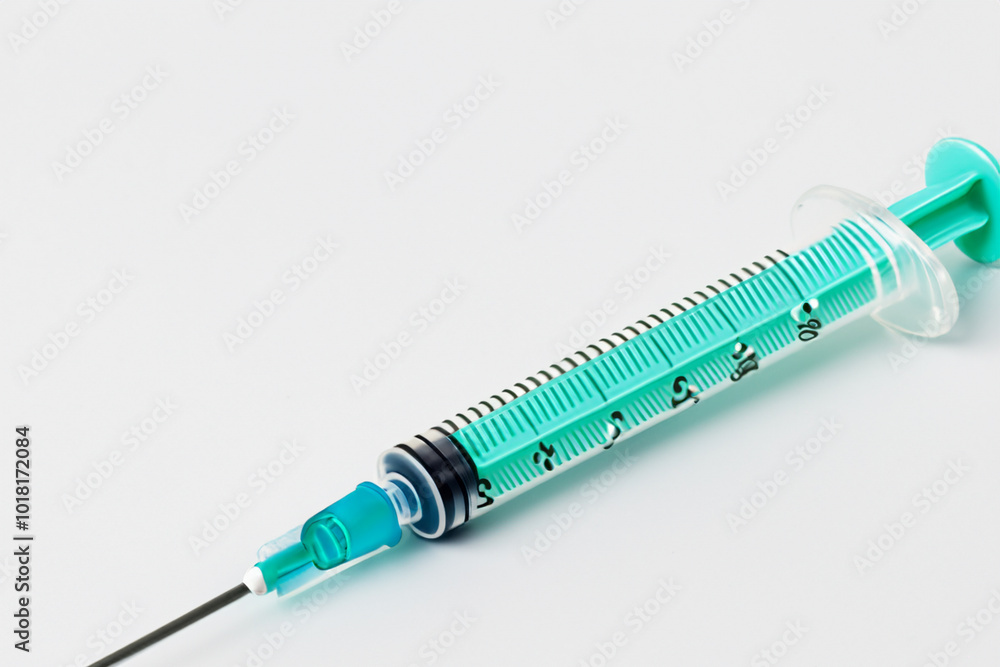 W is preparing syringe for medical use on white . medicine health hospital concept. a small syringe lies on a white . a small syringe lies on a lifestyle white. W is preparing syringe for medical use on white . medicine health hospital concept. a small syringe lies on a white . a small syringe lies on a lifestyle white.