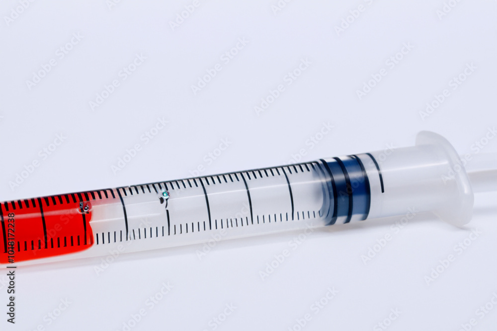 W is preparing syringe for medical use on white . medicine health hospital concept. a small syringe lies on a white . a small syringe lies lifestyle on a white. W is preparing syringe for medical use on white . medicine health hospital concept. a small syringe lies on a white . a small syringe lies lifestyle on a white.