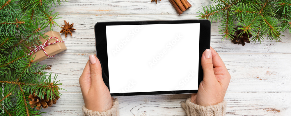 woman hands using tablet computer on wooden table bachground. cristmas shopping time. Happy Christmas mock up background, top view woman hands using tablet computer on wooden table bachground. cristmas shopping time. Happy Christmas mock up background, top view