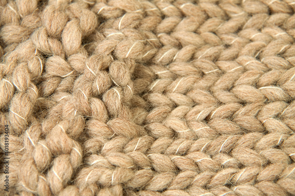 Texture of thick wool woven in light brown color. The wool follows two directions and white thread can be seen Texture of thick wool woven in light brown color. The wool follows two directions and white thread can be seen