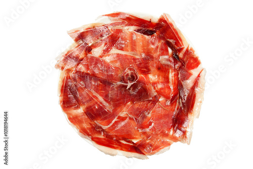 Overhead shot of plate with slices of Serrano ham in circular formation on white background