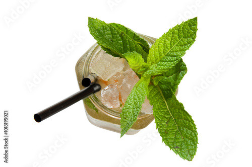 Overhead shot of a mojito cocktail served in a glass with a mint garnish and two black straws on a white background